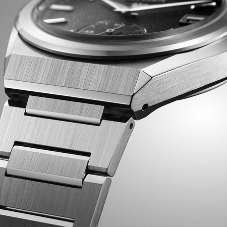 This close-up shows a Citizen watch with a textured white dial, silver hands, and a sub-seconds dial.
