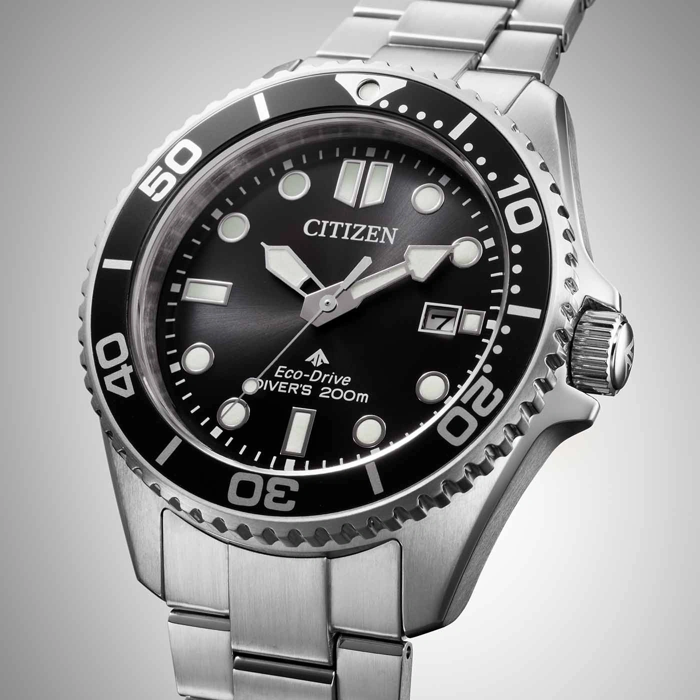 Citizen-Uhr mit schwarzem Zifferblatt und silbernem Armband, Nahaufnahme.