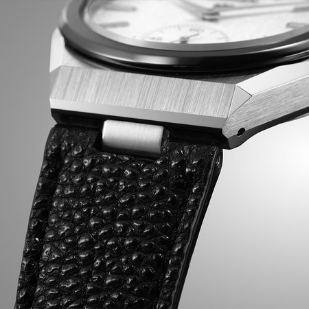 This close-up shows a Citizen watch with a textured white dial, silver hands, and a sub-seconds dial.