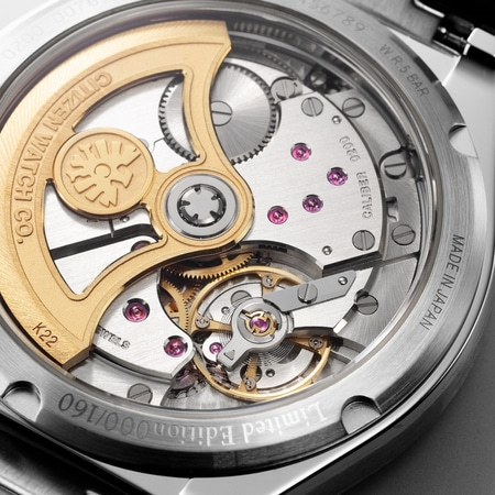 This close-up shows a Citizen watch's transparent caseback, revealing its intricate mechanical movement with golden components, rubies, and engravings.