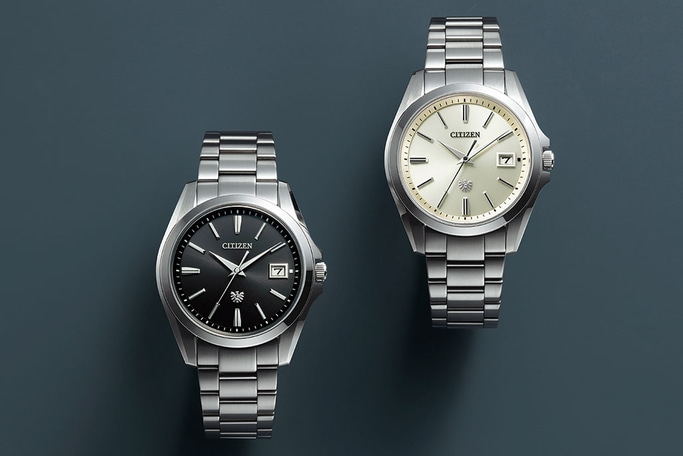 This image displays two elegant Citizen watches side-by-side, both with silver-toned integrated bracelets and cases. One features a textured black dial with a sub-seconds dial, while the other has a textured white dial with a date window.