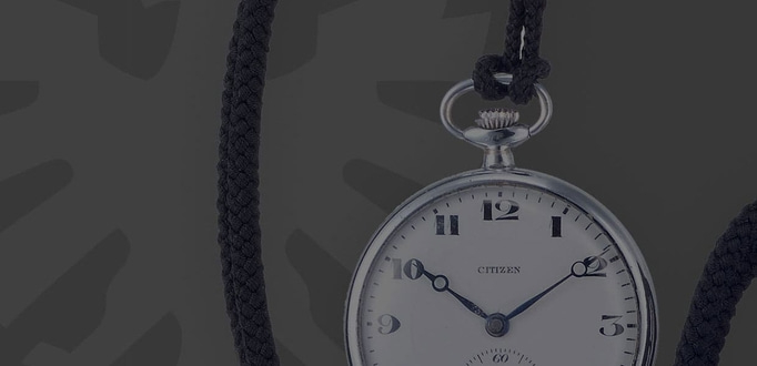 This image features a classic silver-toned Citizen pocket watch from 1924, suspended by a braided black fob. The watch has a white dial with clear black Arabic numerals and a sub-seconds dial, exuding vintage elegance.