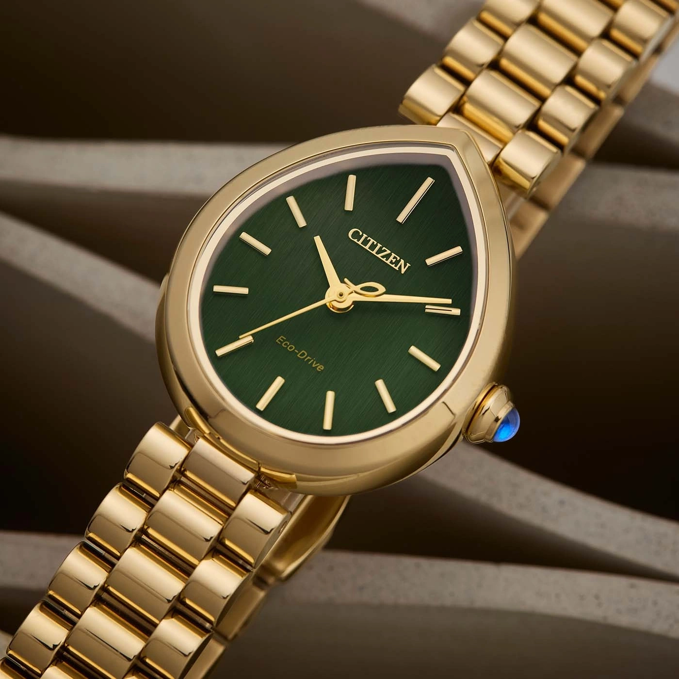 Eine goldene Citizen Eco-Drive Uhr mit grünem Zifferblatt.