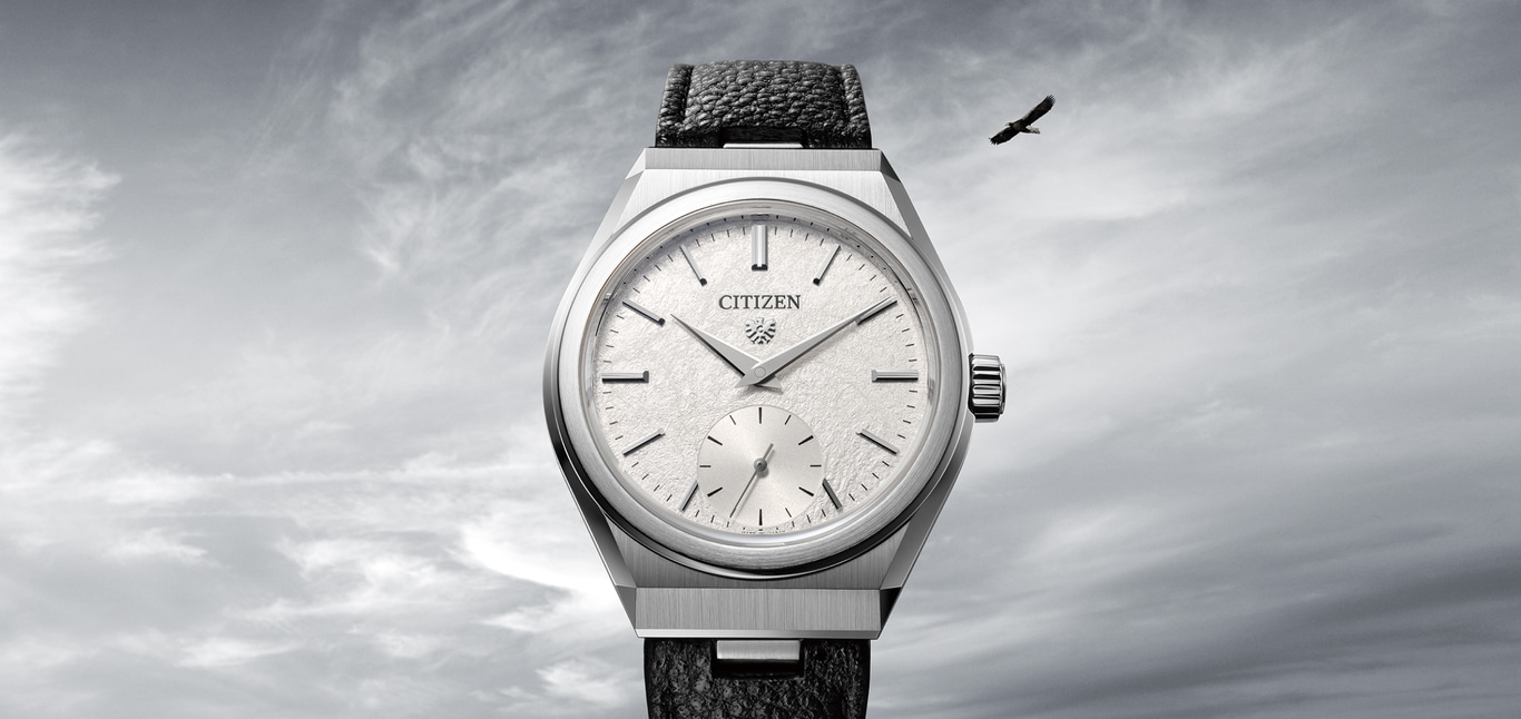 This image features an elegant Citizen watch with a silver-toned case and a textured white dial, paired with a dark strap. A lone bird, likely an eagle, soars in the cloudy sky above, symbolizing freedom and precision.