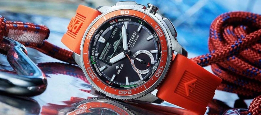Citizen Eco-Drive Uhr mit orangefarbenem Armband und Seilen.