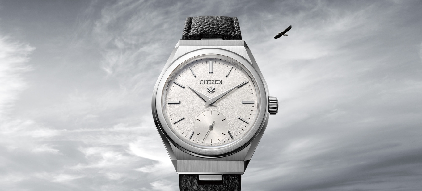 This image features an elegant Citizen watch with a silver-toned case and a textured white dial, paired with a dark, textured strap. A lone bird, likely an eagle, soars in the cloudy sky above, symbolizing freedom and precision.
