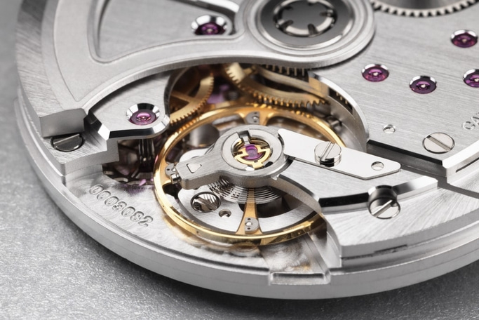 Nahaufnahme eines Uhrwerks mit Zahnrädern und komplizierten Details.