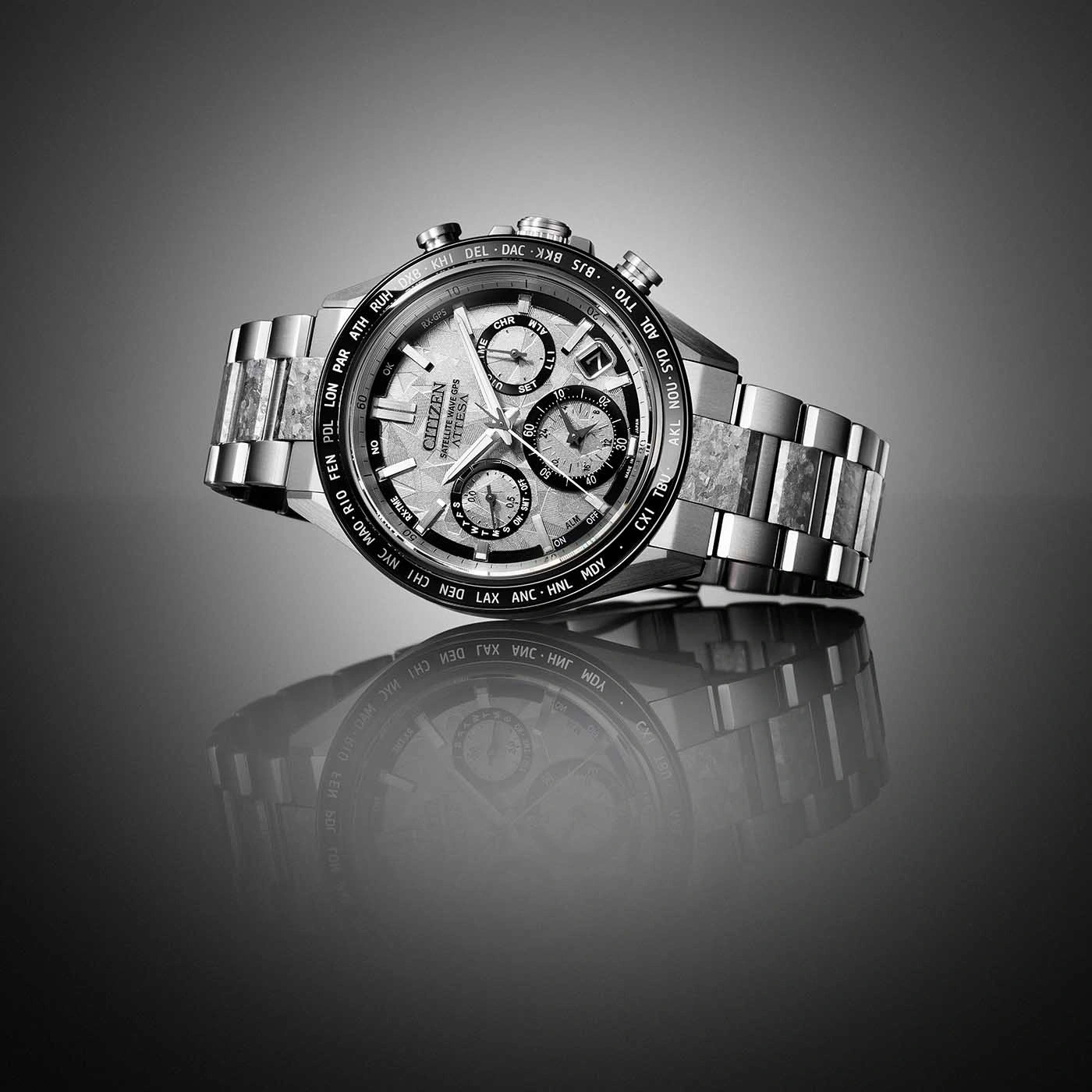 Eine elegante, moderne Citizen-Uhr mit Metallarmband und detailreichem Zifferblatt, auf glatter Oberfläche reflektiert.